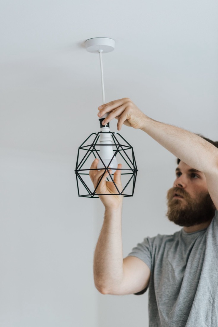 Ampcrest electrician installing a pendant light fixture